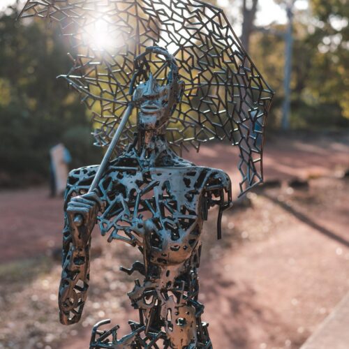 Metal lady in the bush sculpture