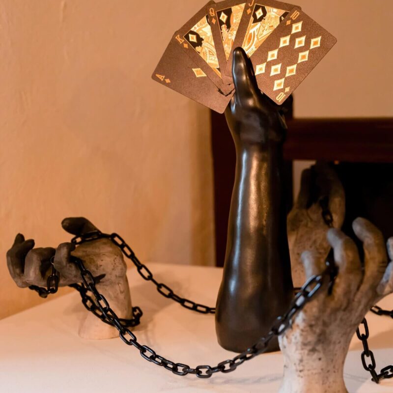 Art sculpture of chained hands playing cards submitted to Youth Art