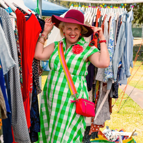 Lady trying on a hat at a stall